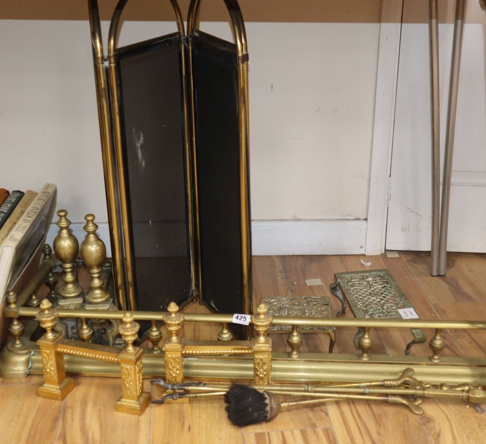 A Victorian brass galleried fire kerb, two kettle stands and fire brasses